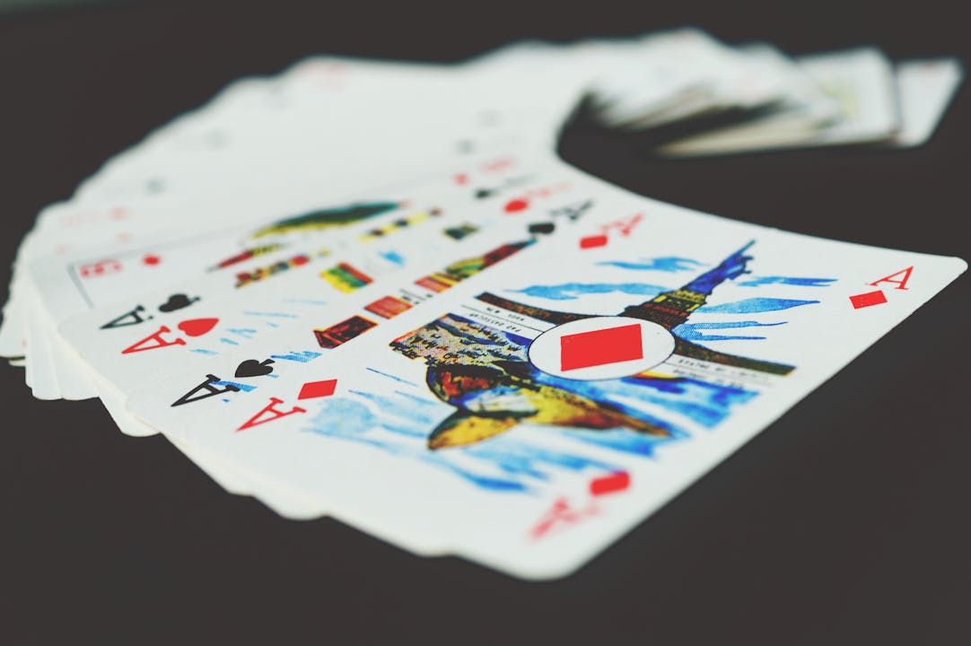 A visually striking close-up of a spread of playing cards showcasing colorful designs and aces.