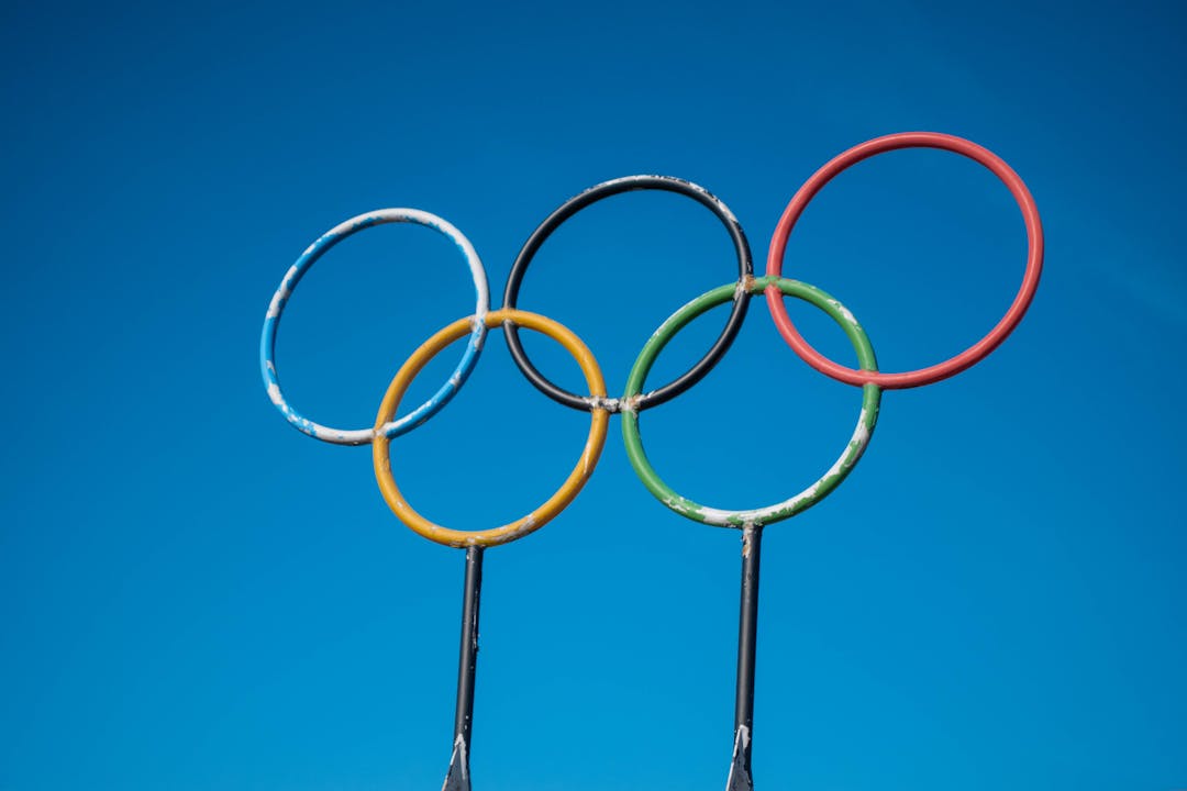 Olympic rings sculpture set against a clear blue sky in Lahti, Finland.