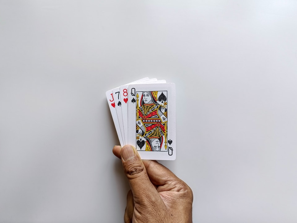 Hand holding a small stack of playing cards.